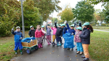 Children collect garbage on a street in Rastatt