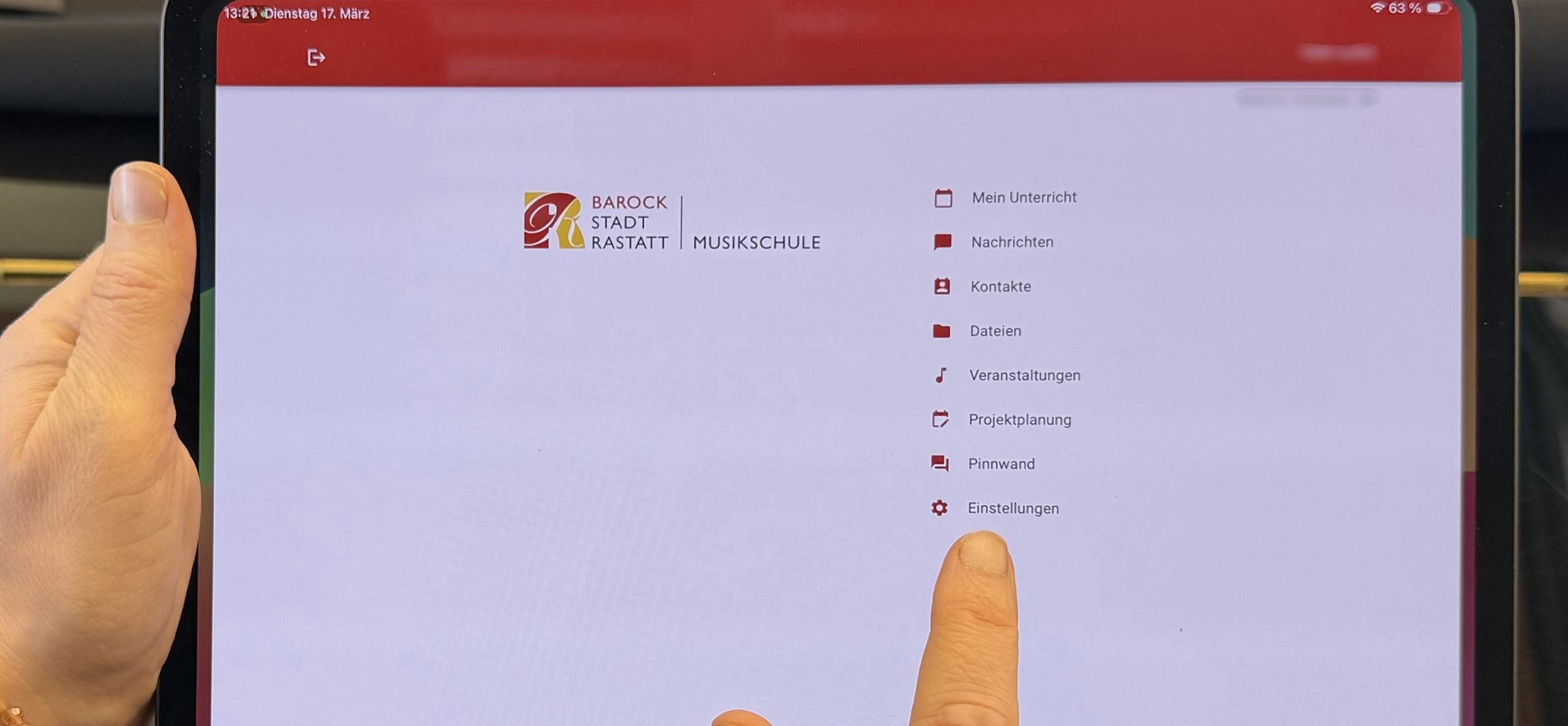 Frau hält Tablet in der Hand und navigiert in der Musikschul-App