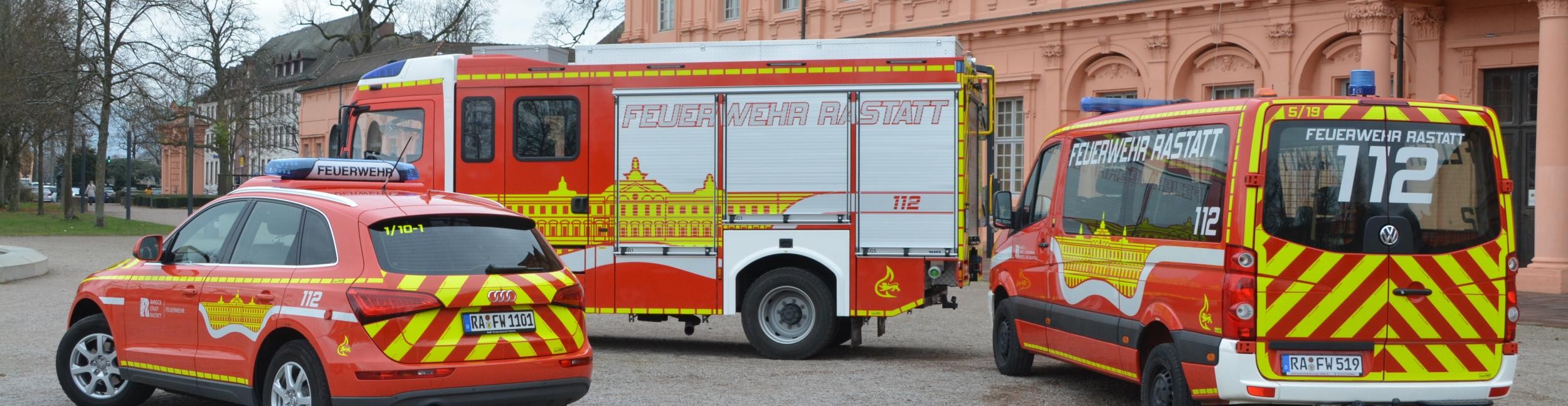 Three fire department emergency vehicles are parked in front of the Rastatt Residence Palace