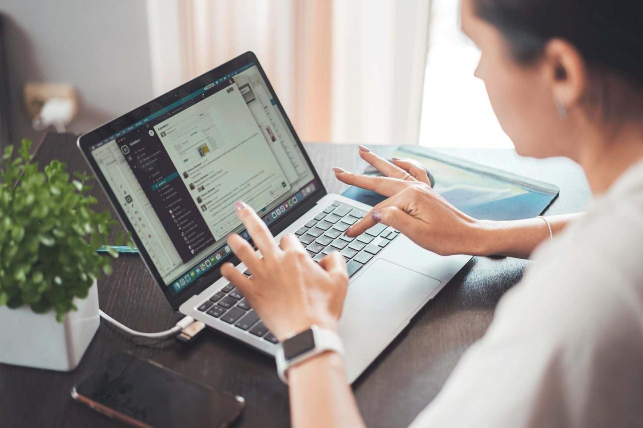 A woman works on a laptop