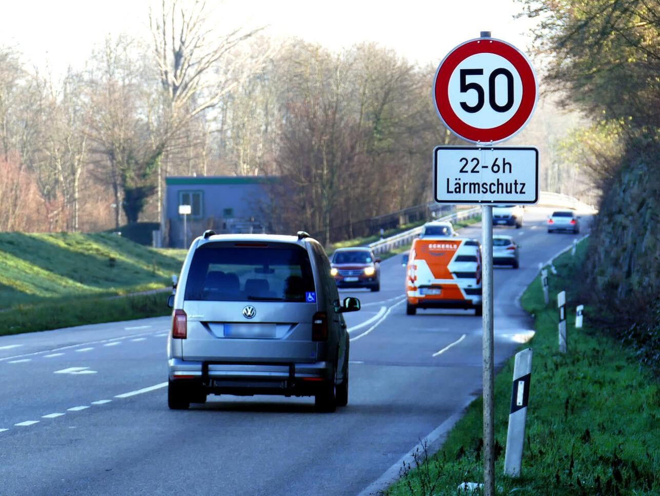 Road in Rastatt with cars, speed limit 50 and noise protection sign