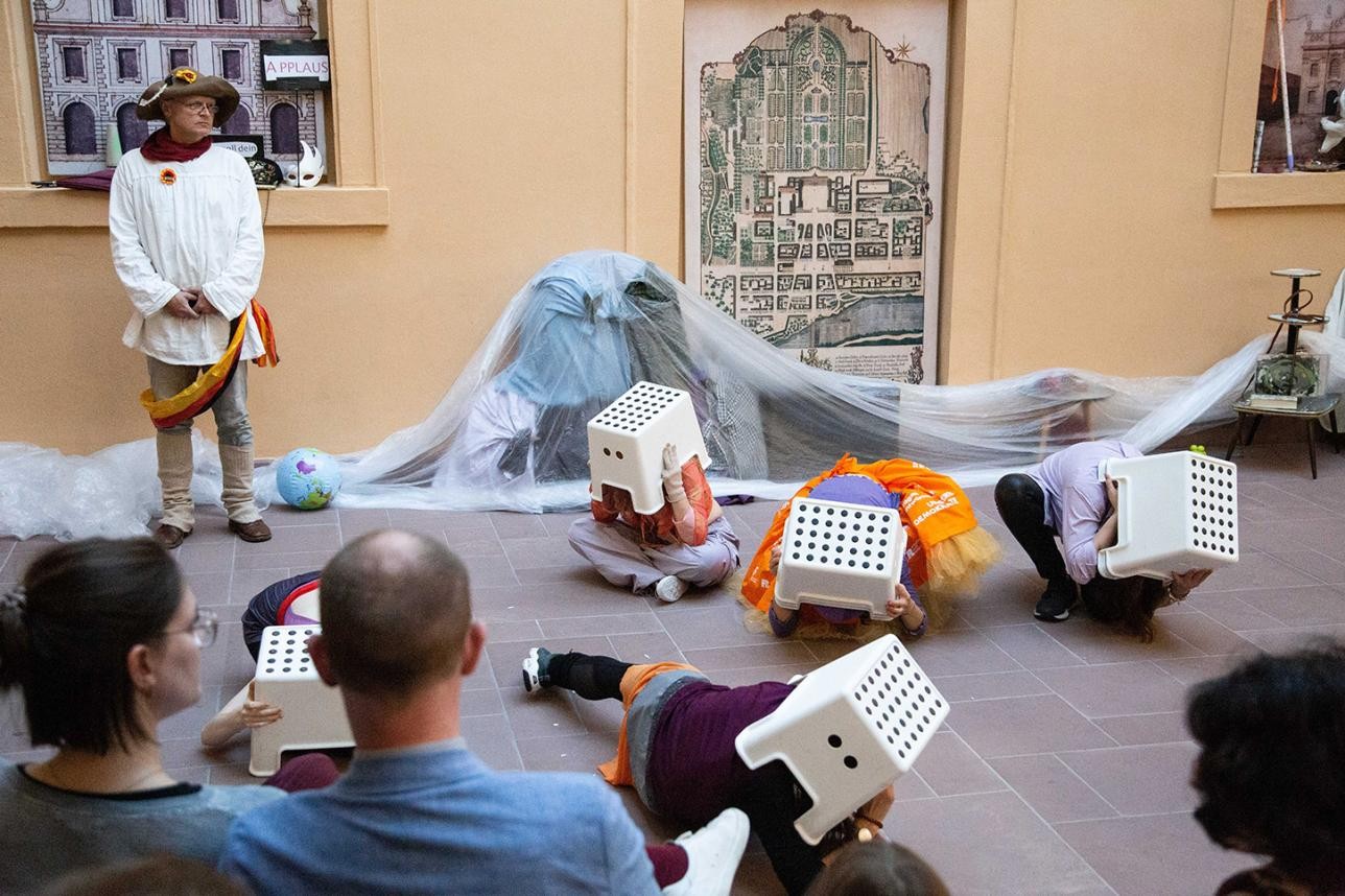Dancers hide under stools