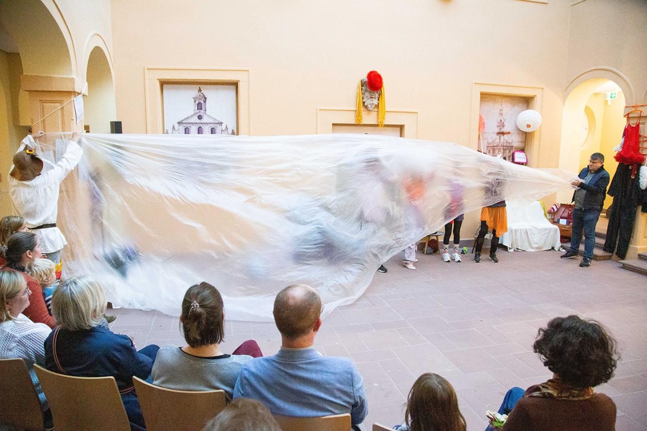 Dance group under a large foil